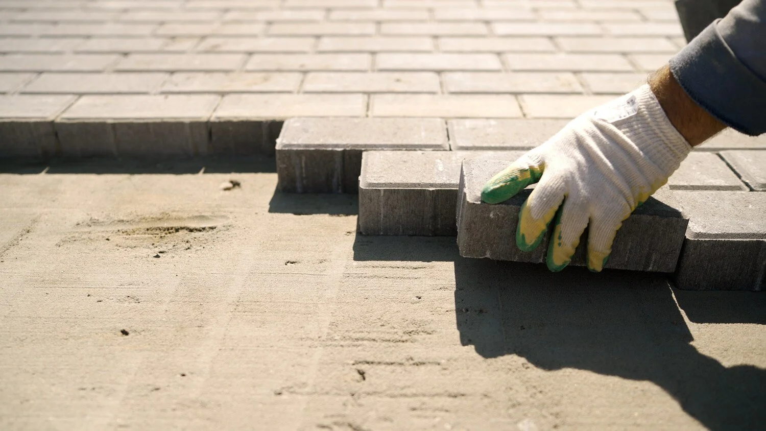 Professional paver installation team working on a custom patio in Jupiter, FL