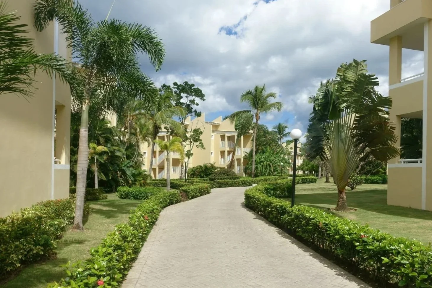 Residential community walkway with concrete pavers and multi-family buildings in Jupiter, FL